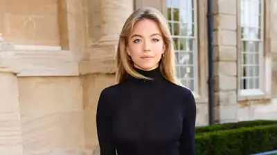 Actress graces the RH England Launch red carpet in a timeless Nensi Dojaka creation, a turtleneck dress with bell sleeves and peplum ruffles, originally featured at London Fashion Week
